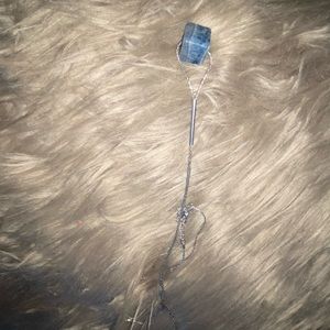 Long silver necklace with blue stone